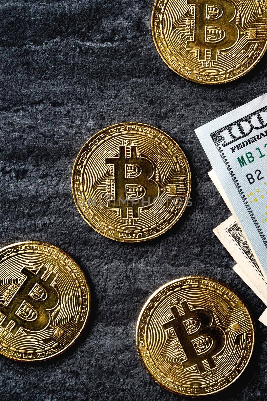 Business top view design concept of cryptocurrency bitcoin with USD Dollar paper currency money over dark black table background.