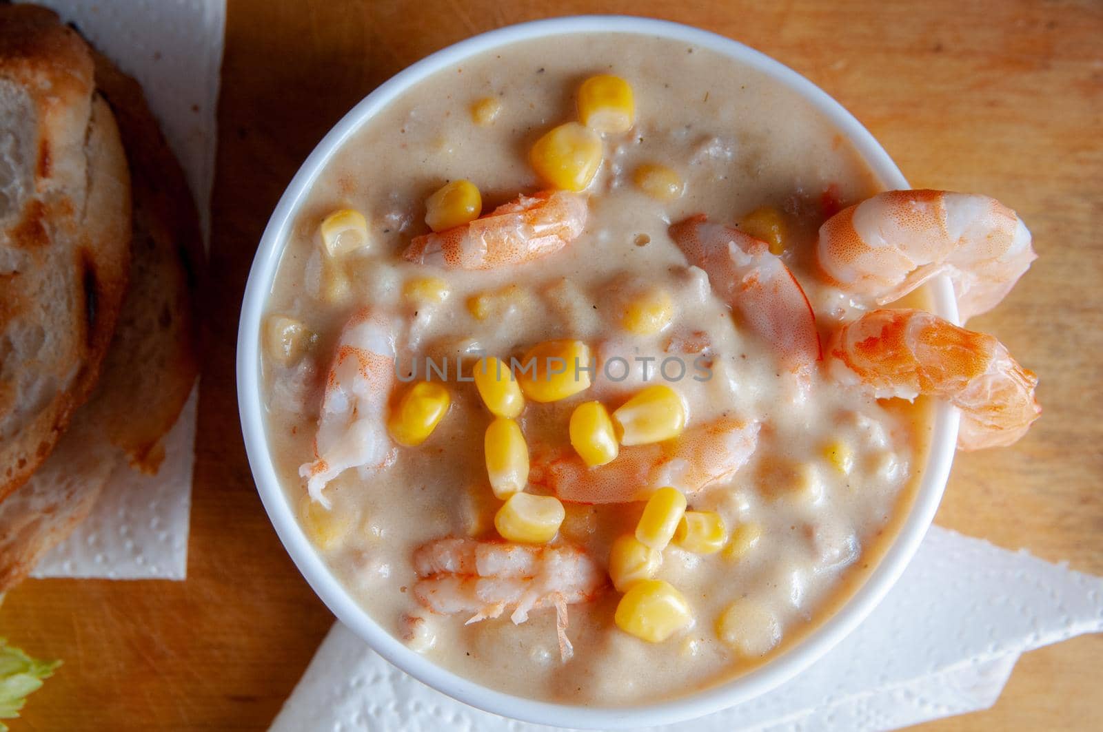 Bowl of homemade corn chowder soup with potatoes, carrots and shrimp.English shrimp chowder soup