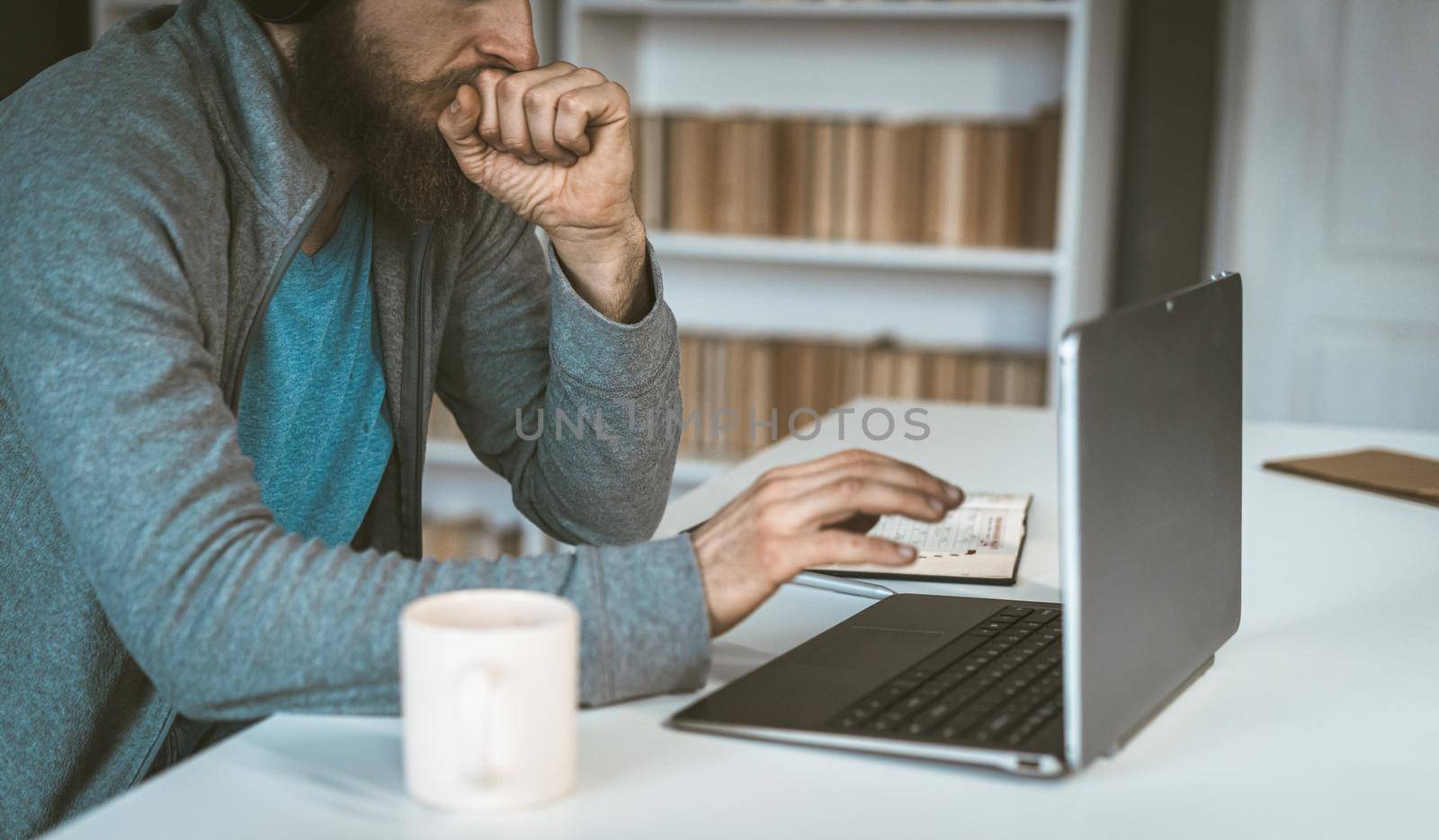 Sad European works in the Internet. A man thinks in front of a computer. The concept of choice. High quality photo