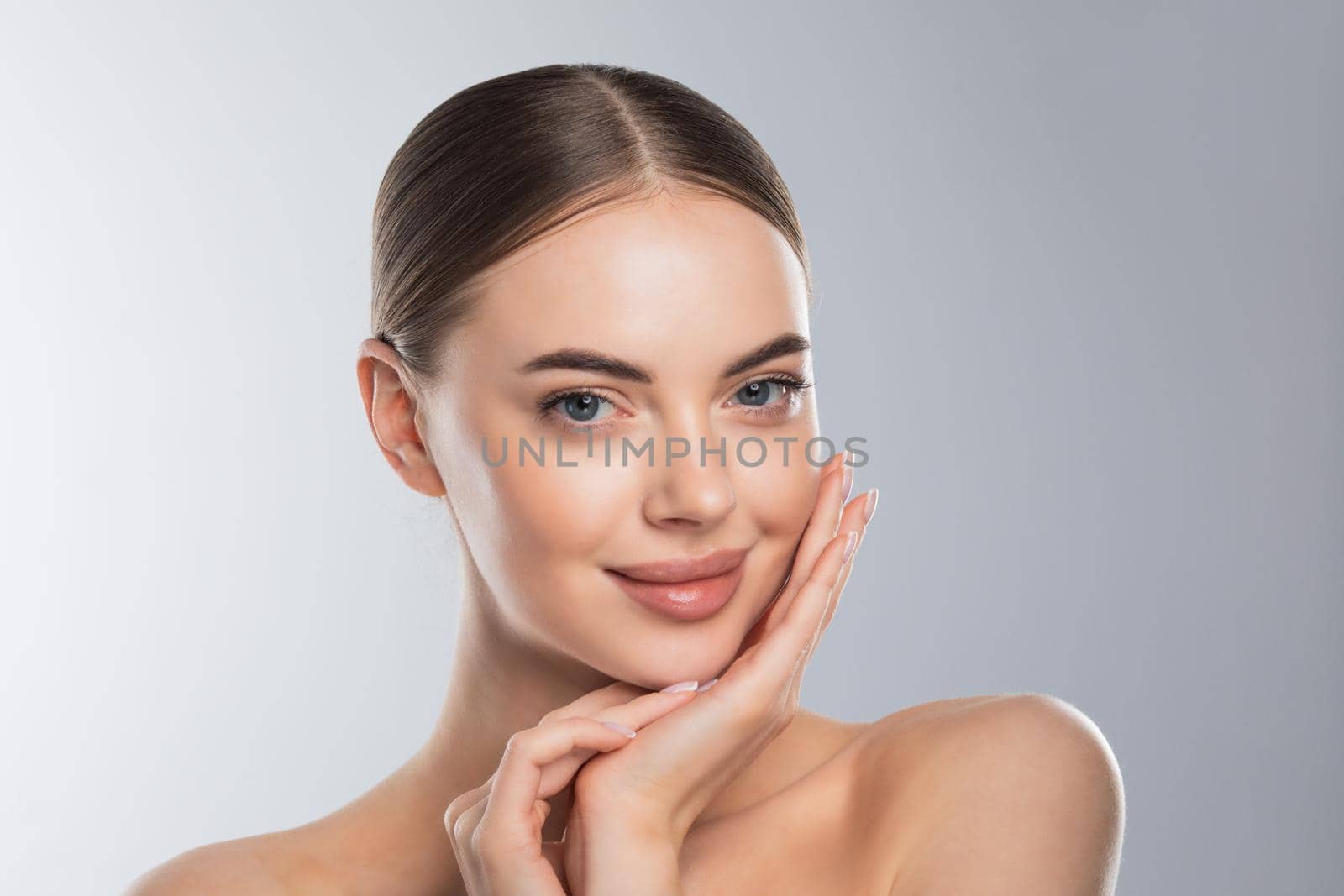 Beauty model girl face portrait . Beautiful woman touching face enjoy perfect skin