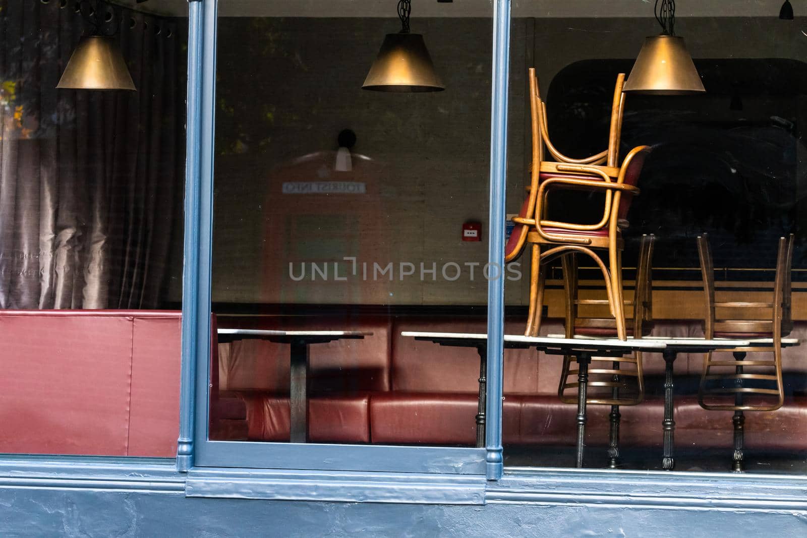 Window of an empty restaurant forced to close amid COVID-19 pandemic by mauricallari