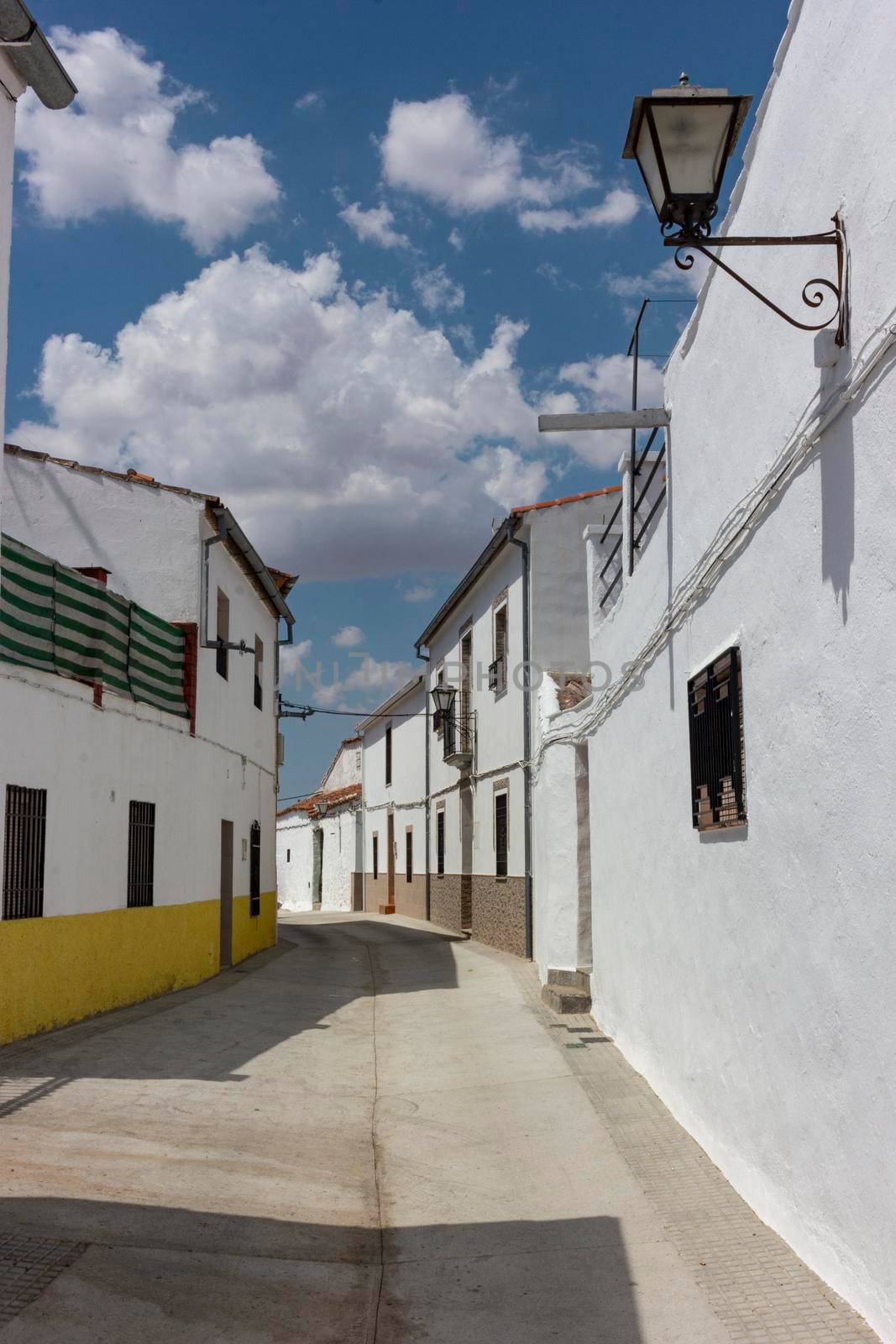 Village in the Andalusian countryside with a cloudy sky by loopneo