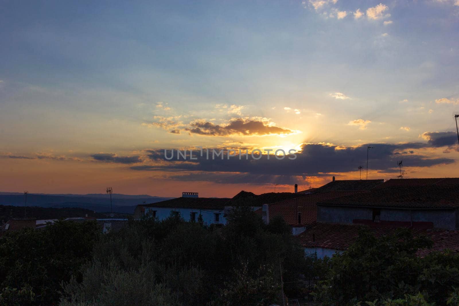 Backlit sunset with yellow, red and blue colors in southern Andalusia, Spain