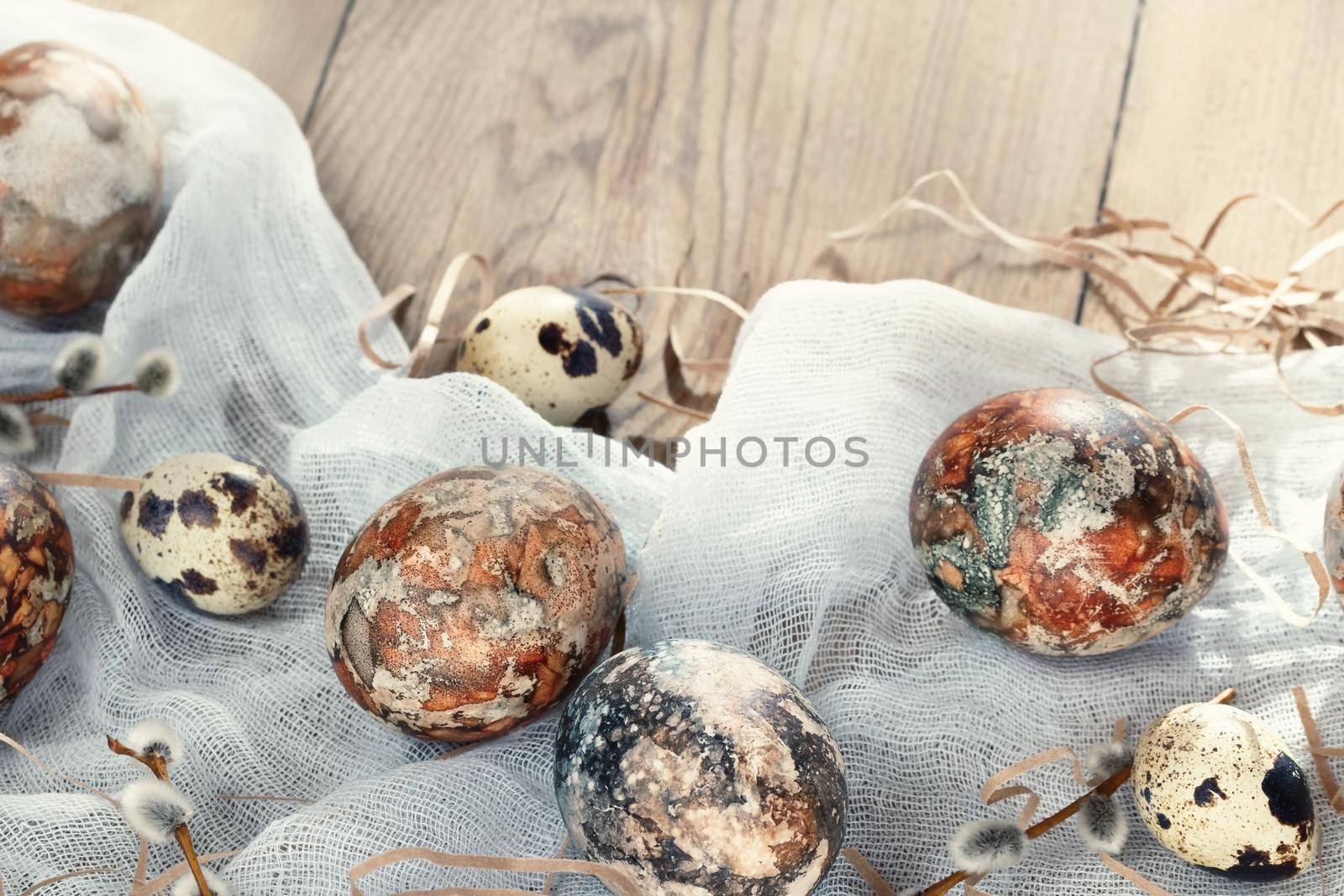 Easter composition - Easter eggs painted with natural dyes on a wooden table.