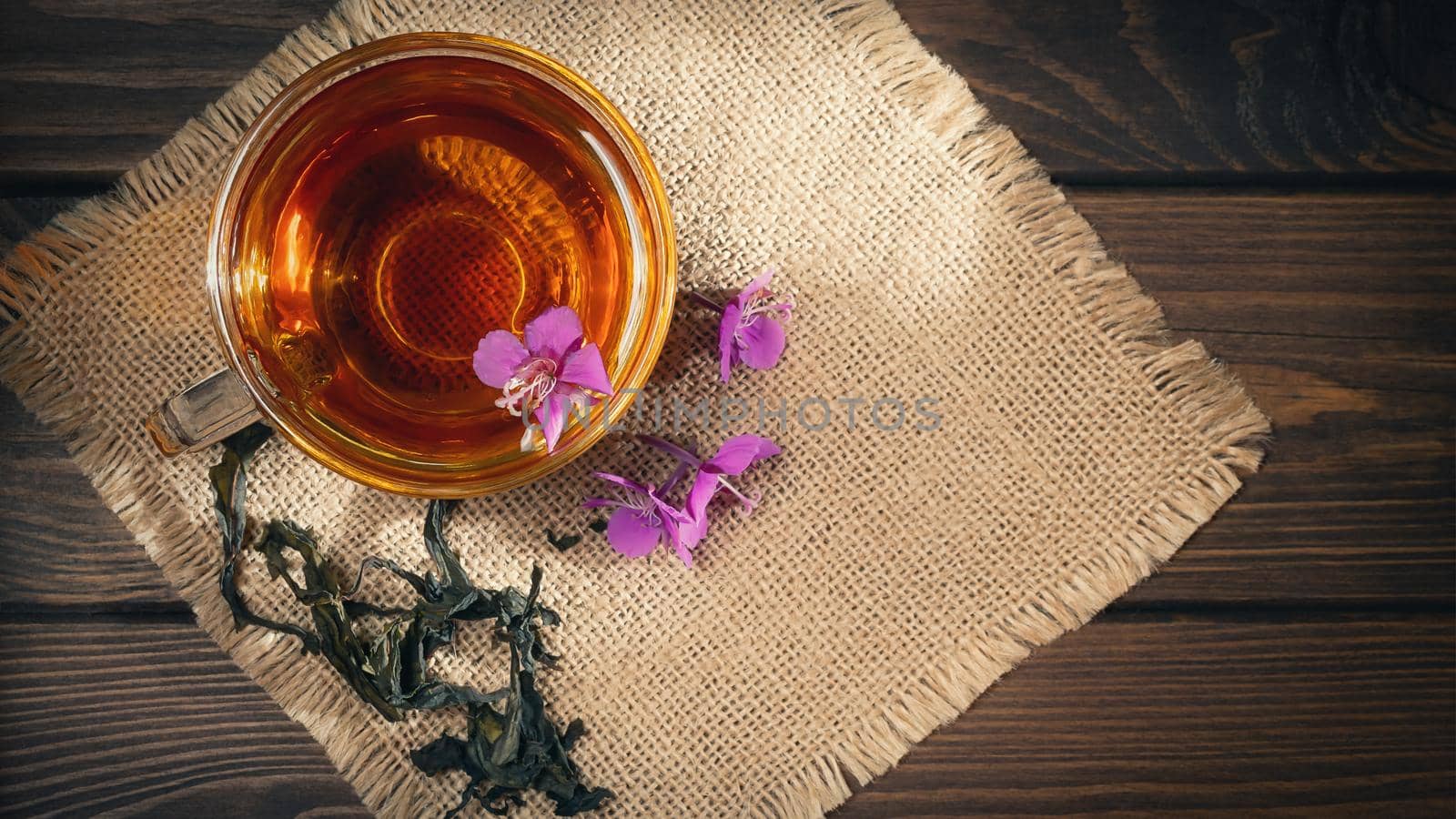 Herbal tea made from fireweed known as blooming sally in cup, top view, copy space.