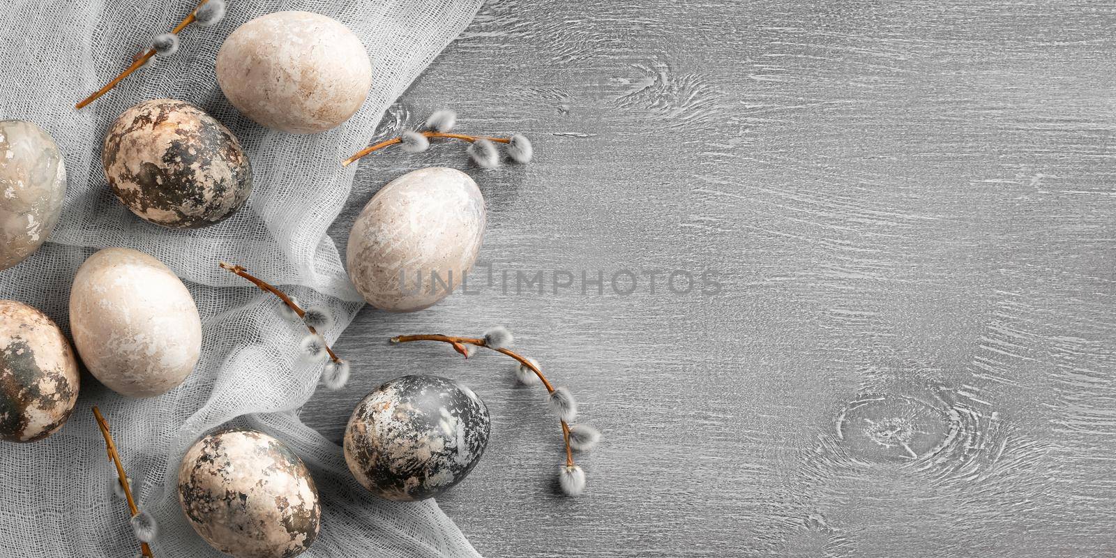 Easter composition - several painted with natural dyes with marble effect on the table, top view, copy space.