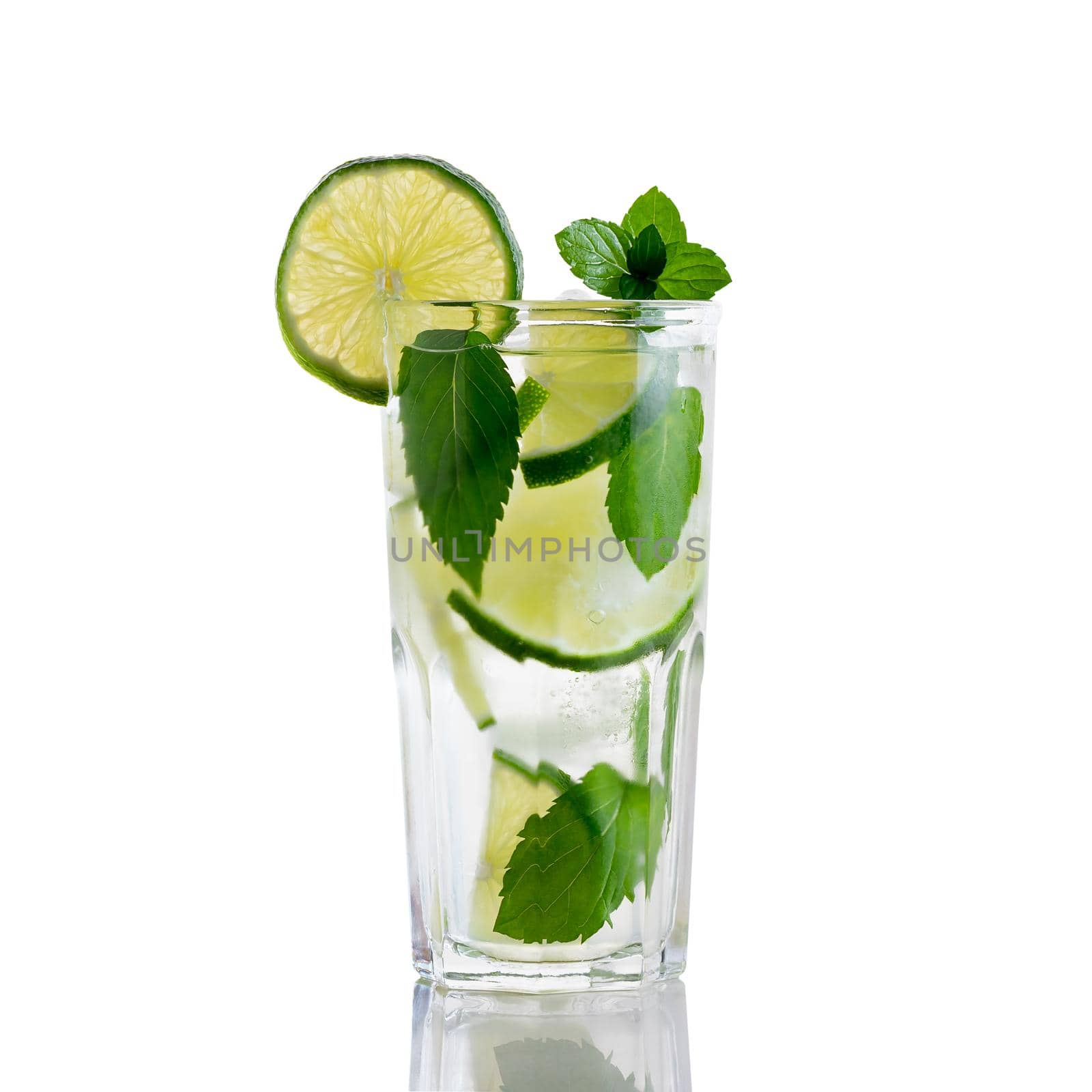 Fresh homemade mojito cocktail in a tall glass with lime, mint and ice isolated on white background.