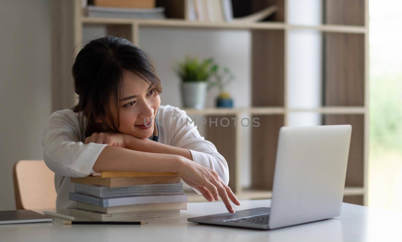 Young asian woman student study at home using laptop and learning online by nateemee