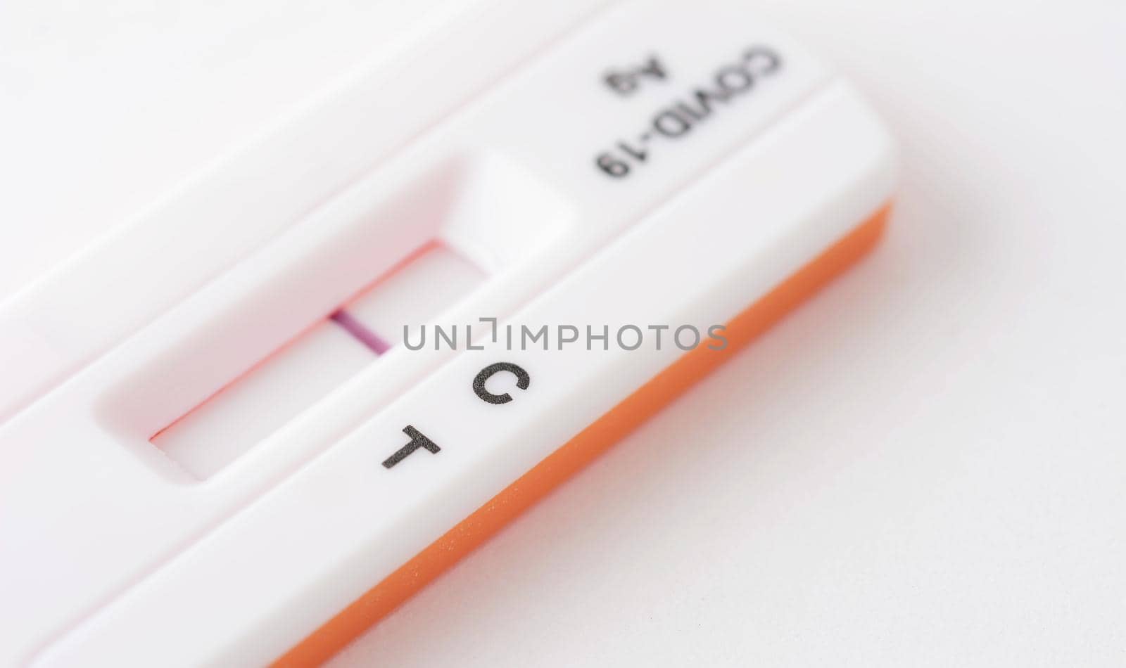 Home antigen test for capturing of COVID-19 antibodies on white background. It shows negative result. 