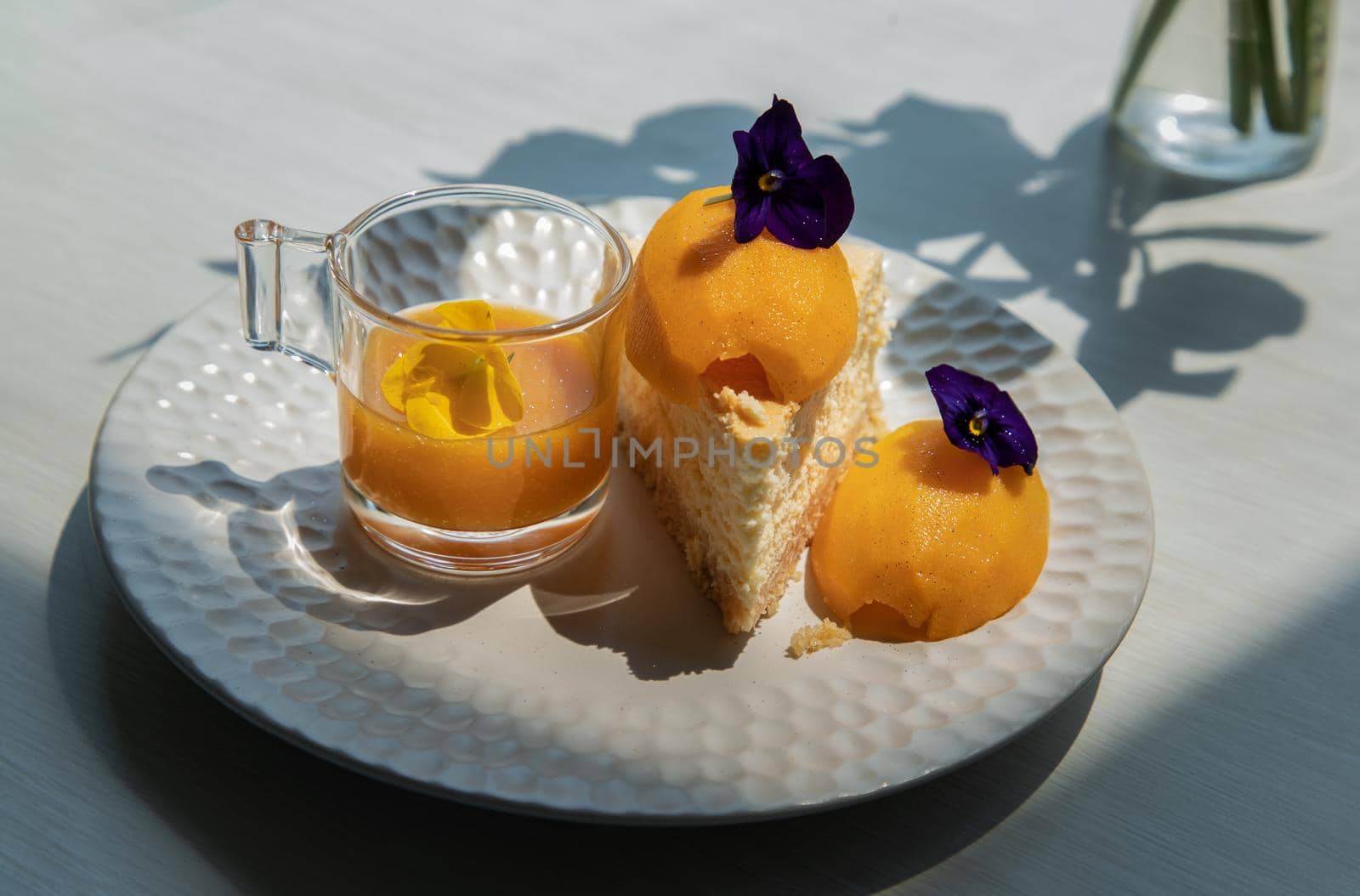 Traditional sweet dessert : Mayomgchid cheesecake on white plate, White table background. Delicious seasonal breakfast, Selective focus.