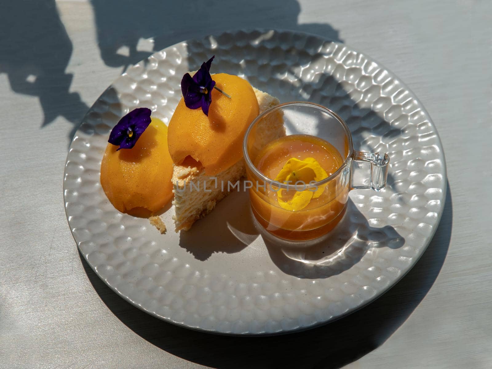 Traditional sweet dessert : Mayomgchid cheesecake on white plate, White table background. Delicious seasonal breakfast, Selective focus.