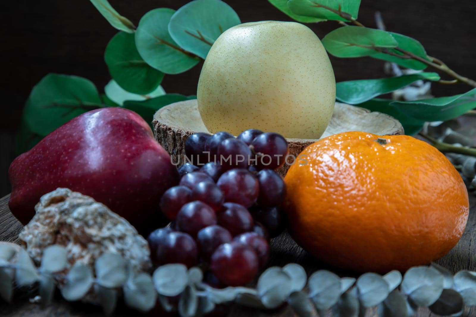 Variety of fresh assorted fruits on the old wooden table. Assorted fruits colorful background, healthy fruits, Dark tone, Selective focus.