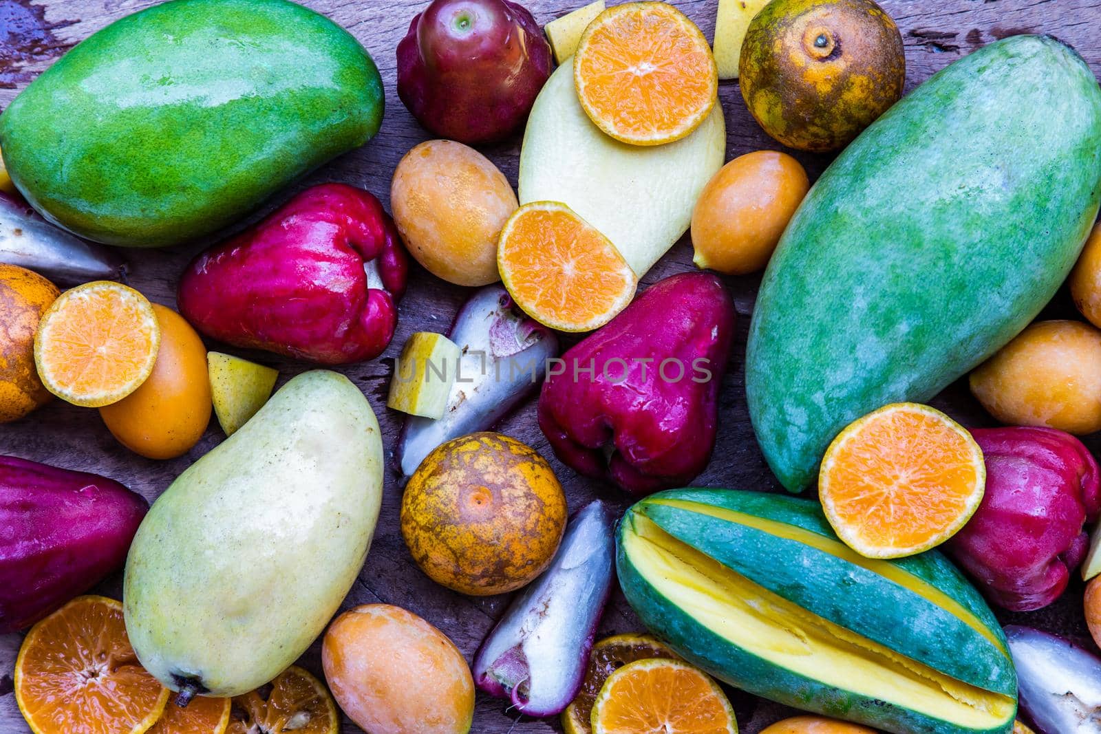 Variety of fresh assorted fruits on the old wooden table. Assorted fruits colorful background, healthy fruits, Selective focus.