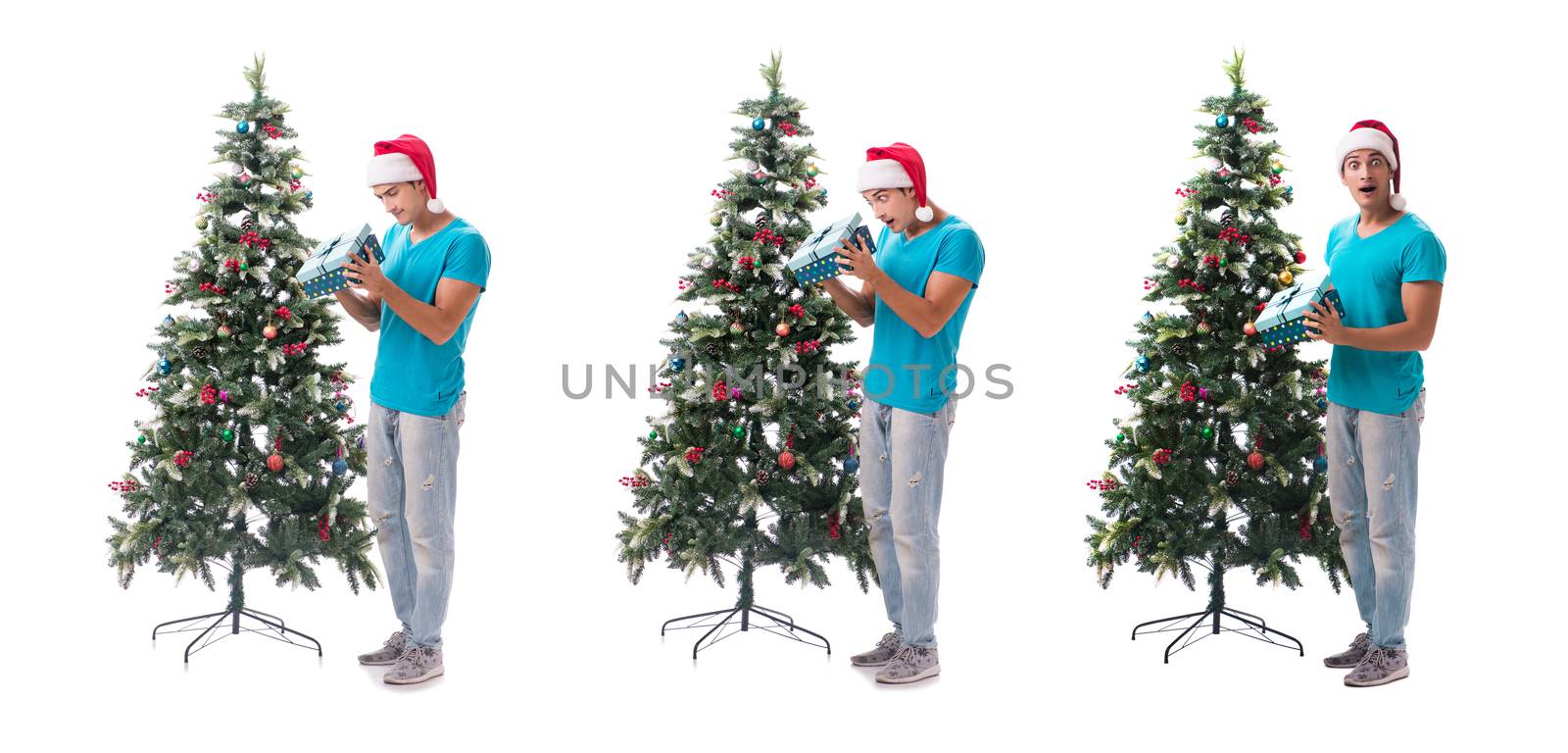 Young man decorating christmas tree isolated on white