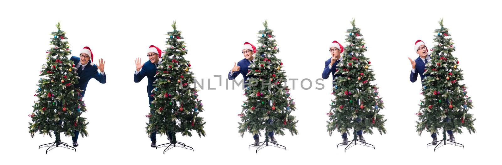 Businessman decorating christmas tree isolated on white