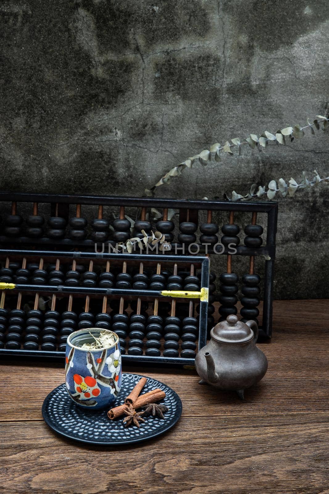 Chinese herbal tea and Vintage wooden hand abacus over Old wood table.  by tosirikul