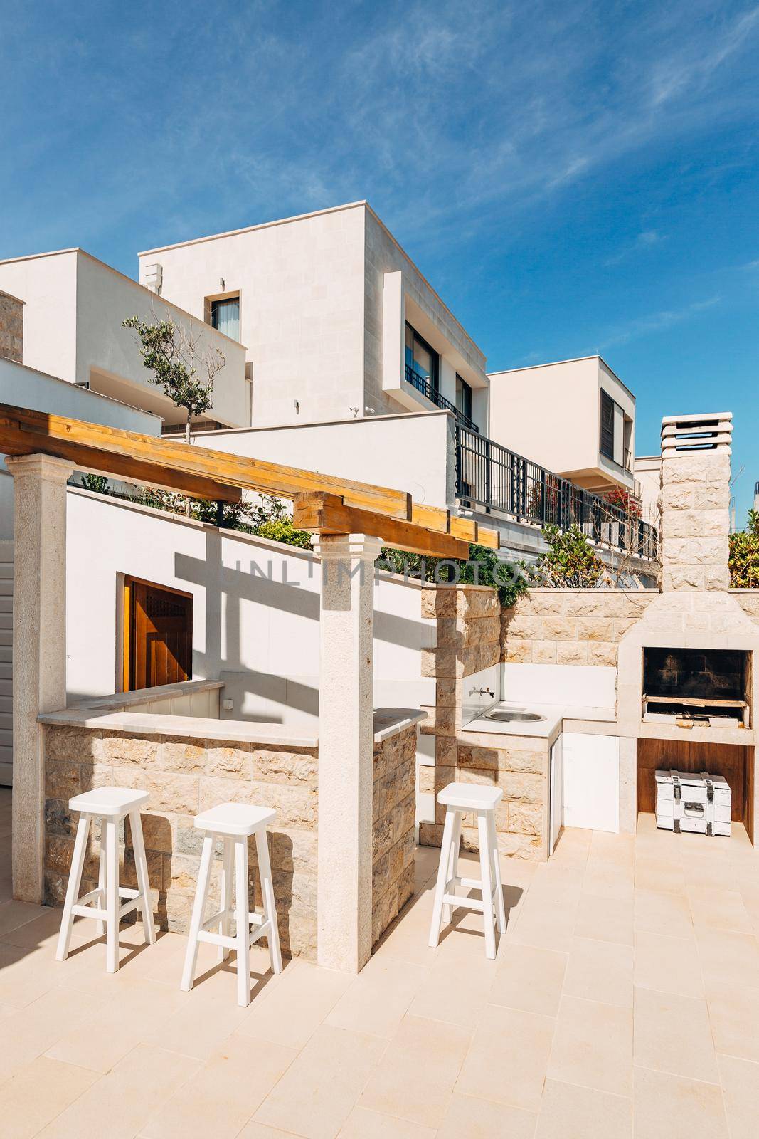 Grill area in the villa by the sea. A large courtyard with a stone grill and an open white stone kitchen. by Nadtochiy
