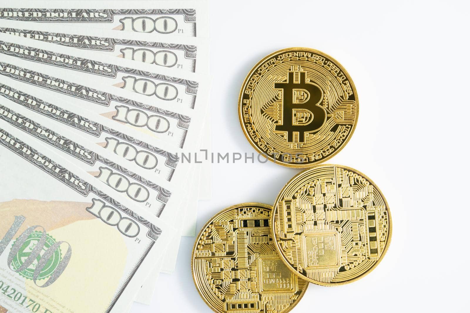 Bitcoins coin and  US banknotes of one hundred dollars by stoonn