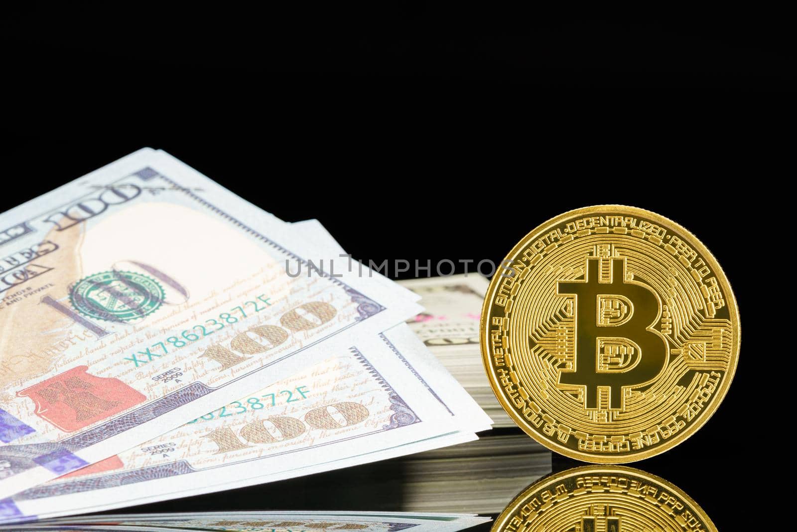 Golden Bitcoins and  US banknotes of one hundred dollars by stoonn