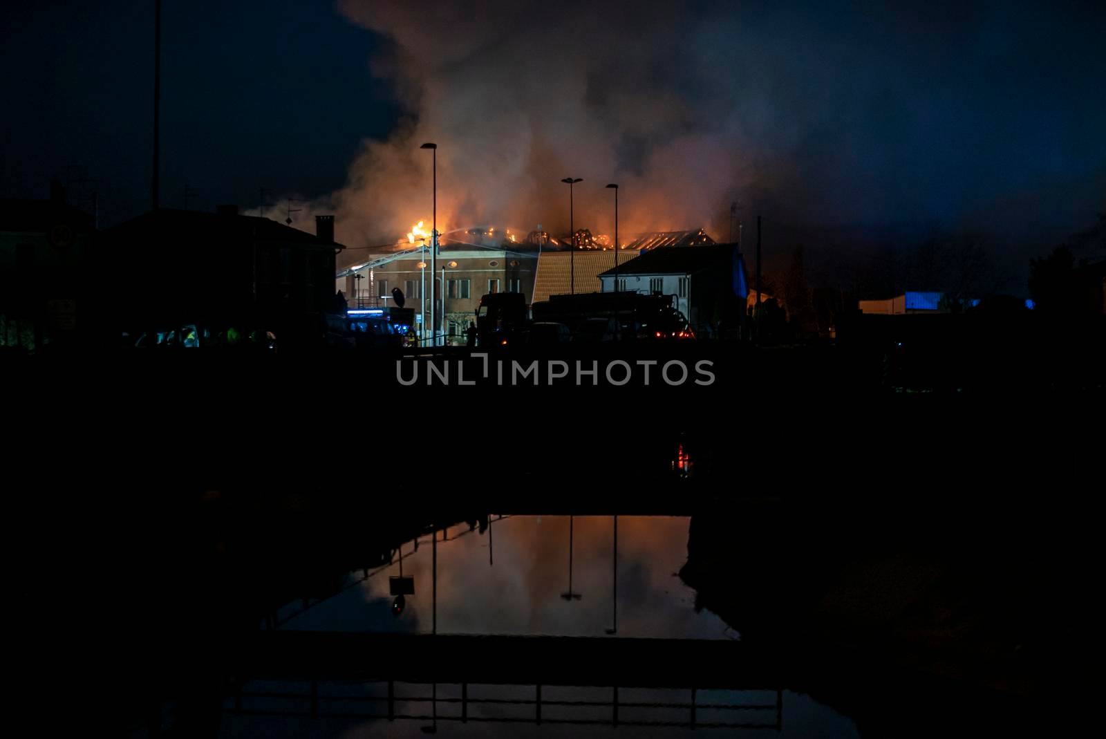 House burning at night with firefighters 7 by pippocarlot