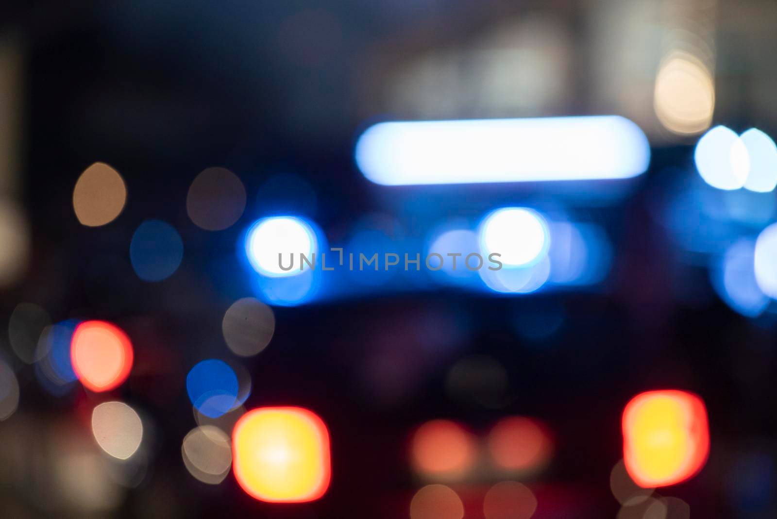 Detail of Blurred emergency background with blue lights in the city at night