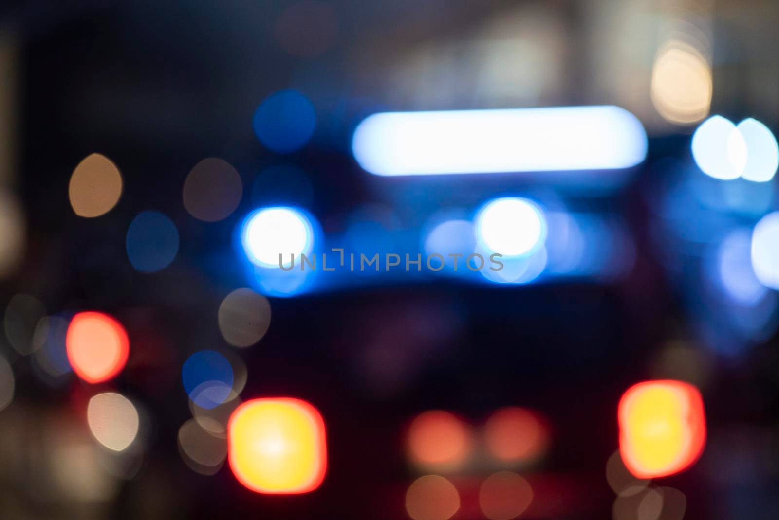 Detail of Blurred emergency background with blue lights in the city at night