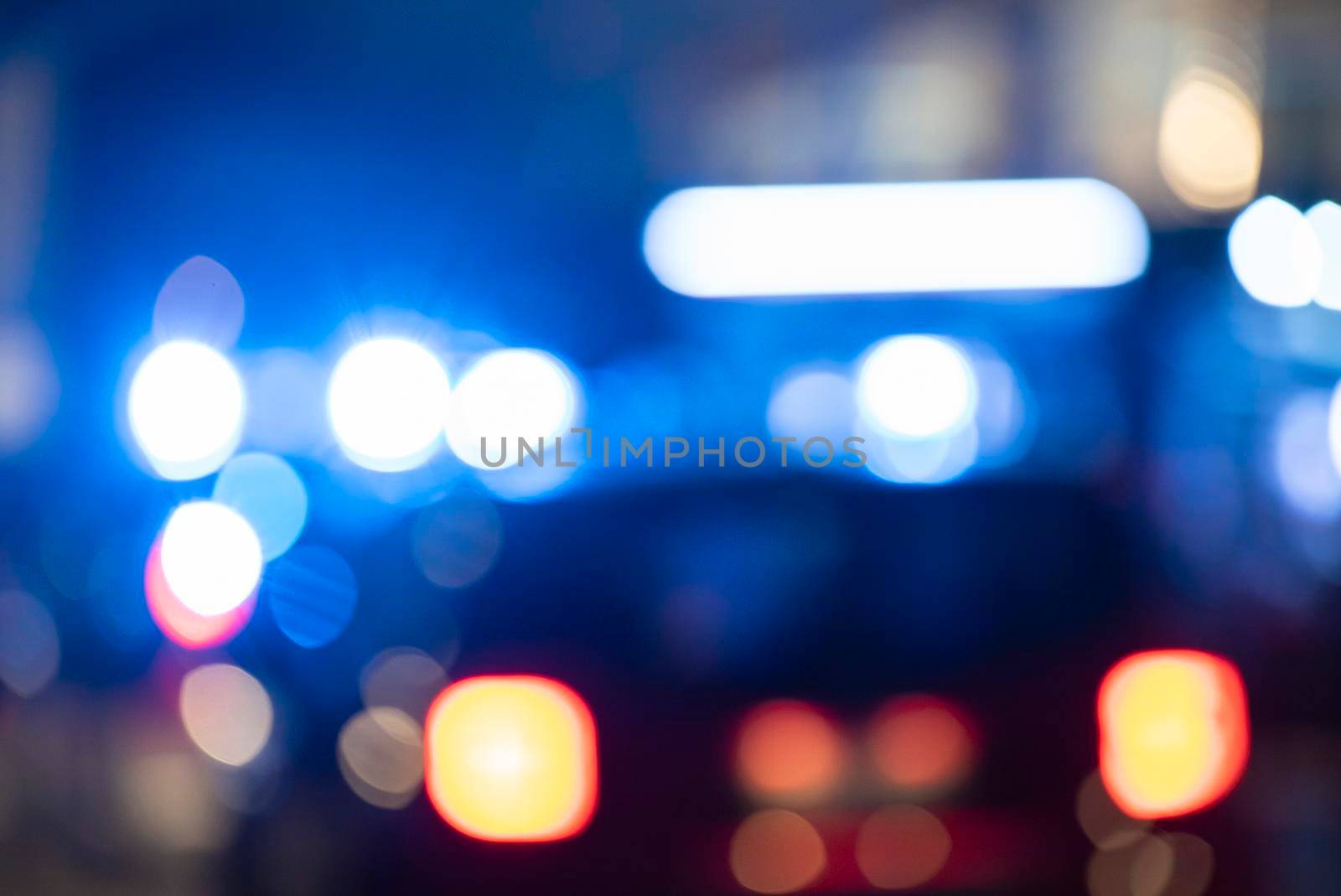 Detail of Blurred emergency background with blue lights in the city at night