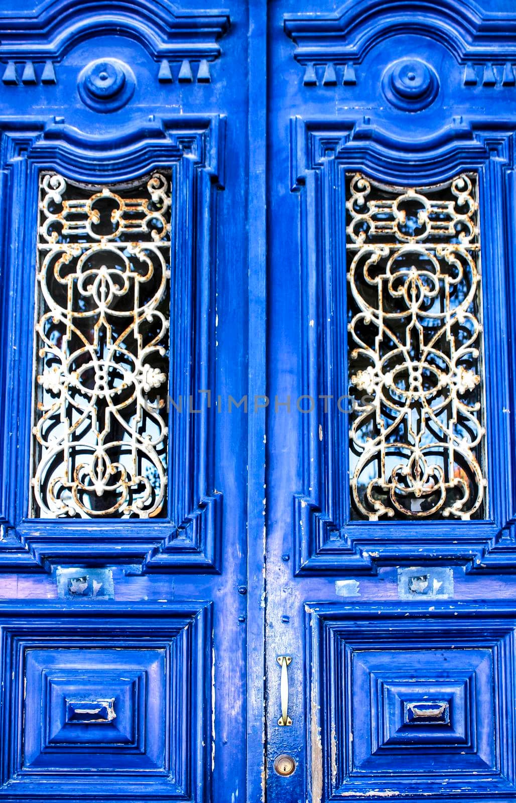 Old colorful blue carved wooden door in Lisbon, Portugal
