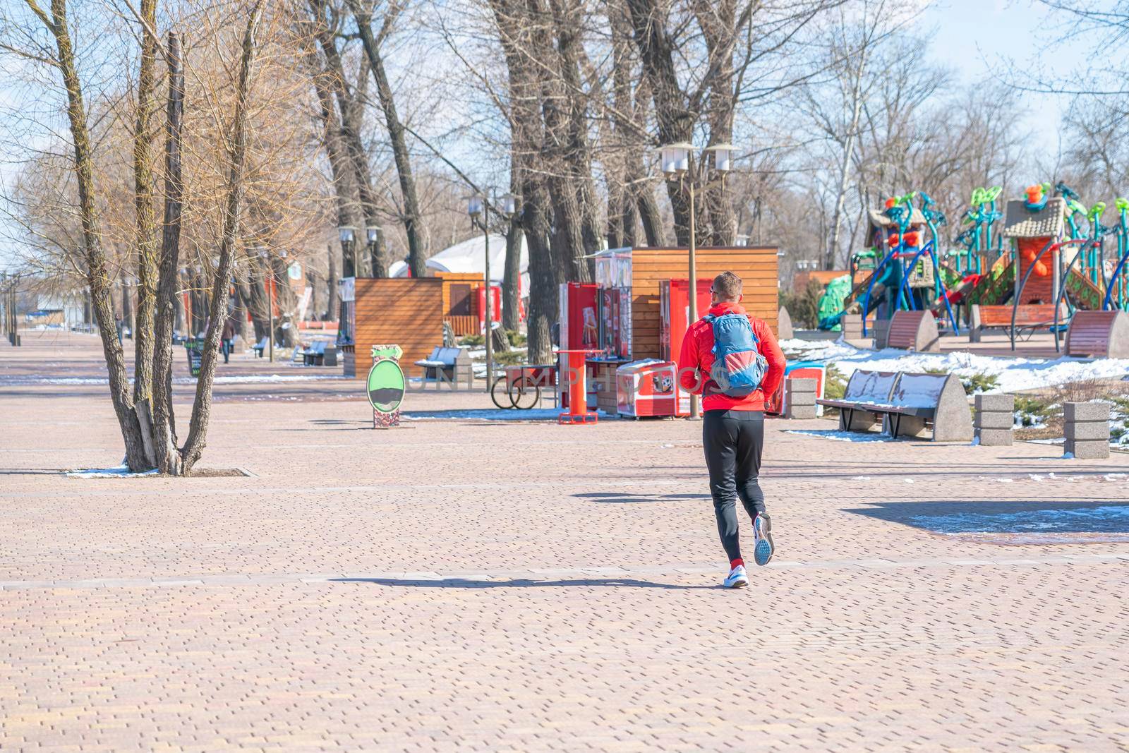 human athlete running on the park pavement. High quality photo