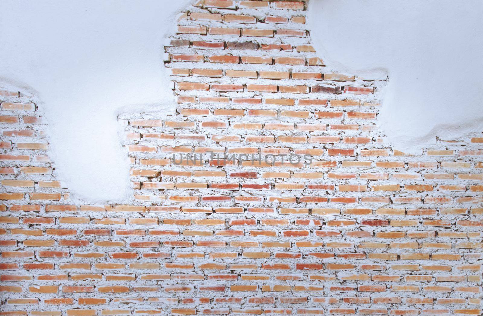 Empty old brick wall painted texture happy red-brown wall wide grunge brick wall shabby building with damaged plaster abstract web banner copy space.