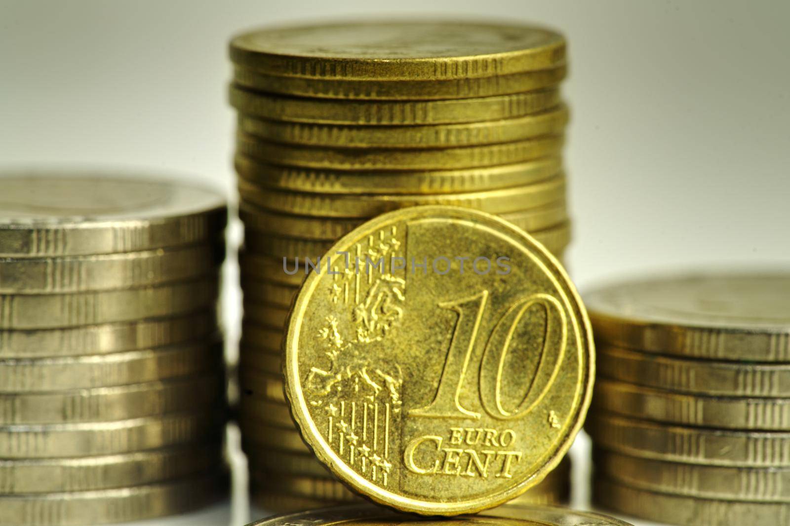 A close-up of 10 cent coins and other coins stacked up. Show the concept of flourishing investment and financial valuation.