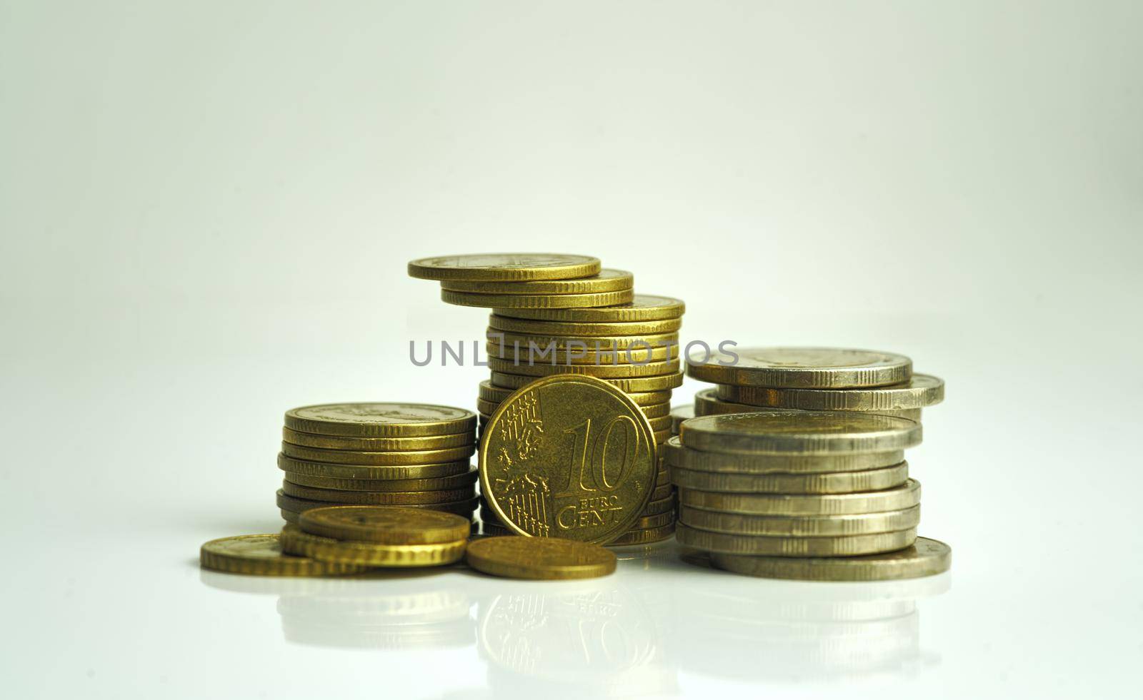 A close-up of 10 cent coins and other coins stacked up. Show the concept of flourishing investment and financial valuation.