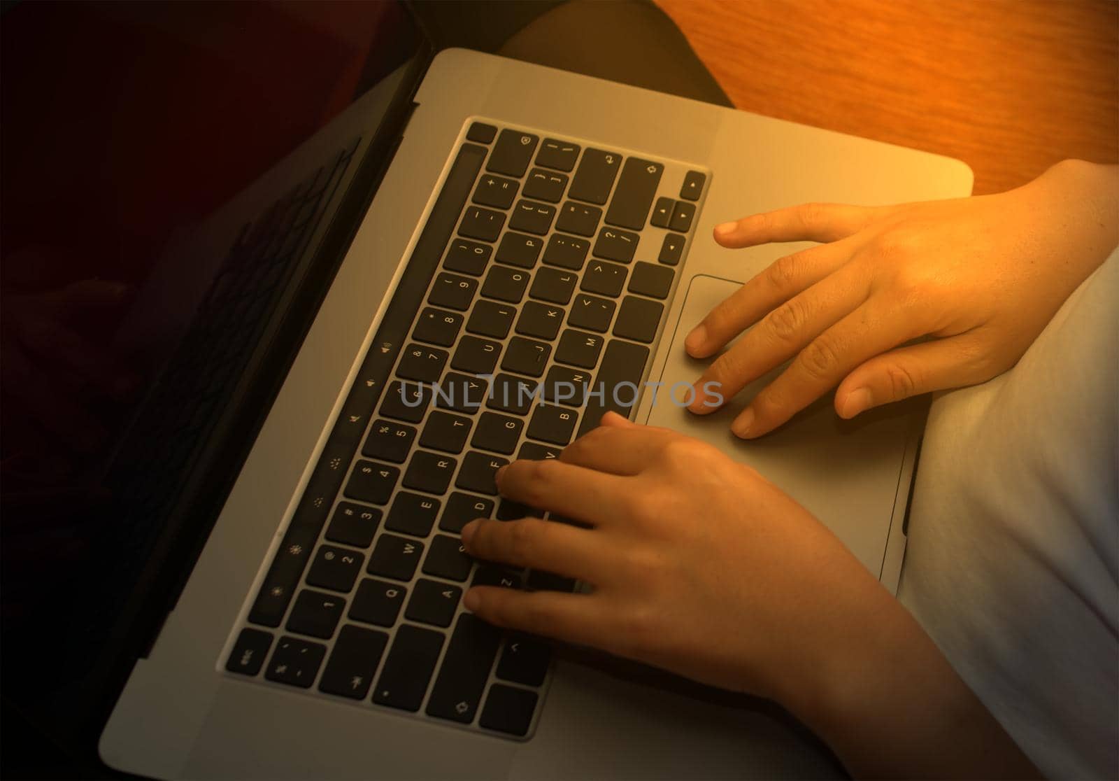 Girl hand typing laptop keyboard in concept coffee shop Wireless data entry and technology.