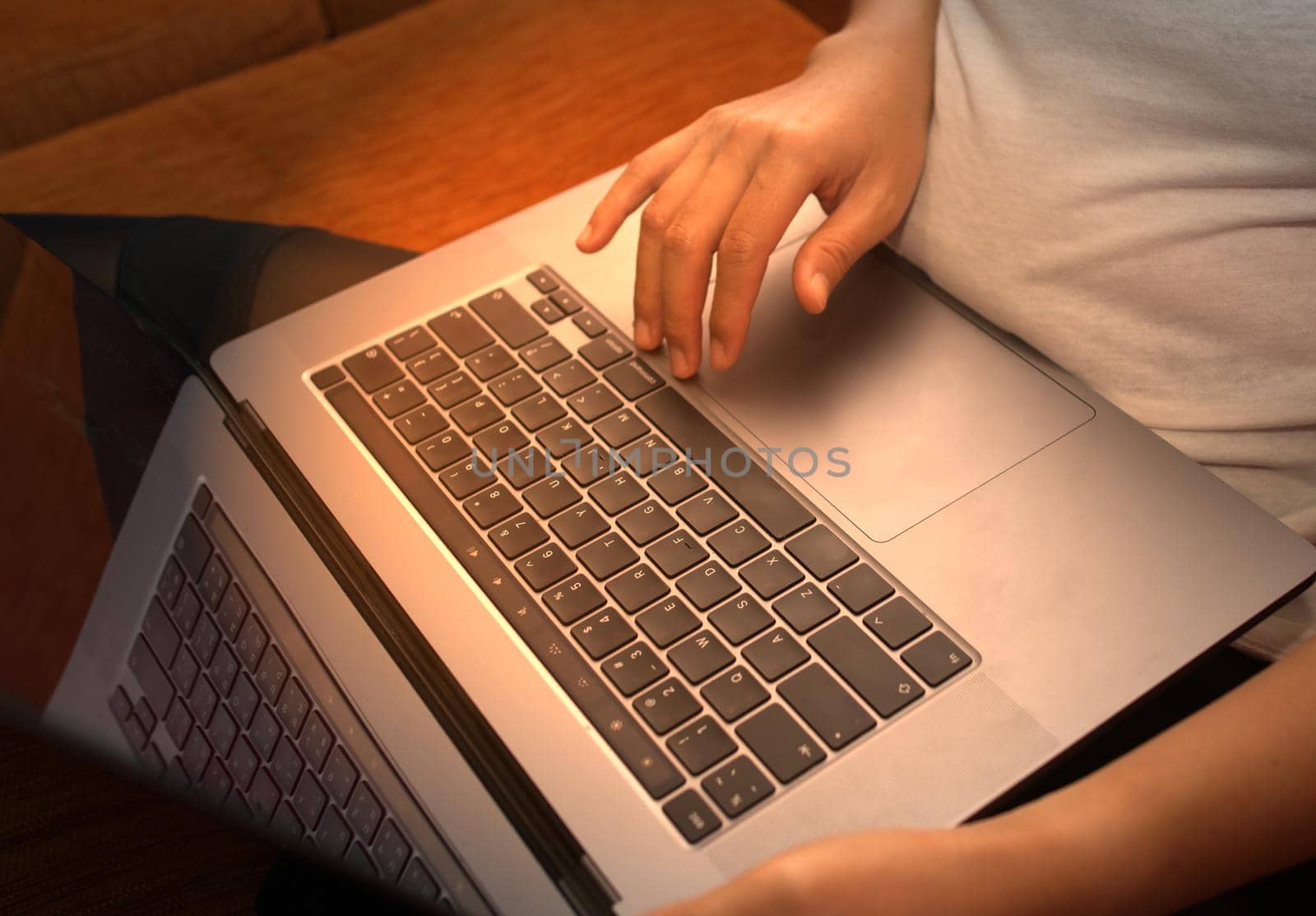 Girl hand typing laptop keyboard in concept coffee shop Wireless data entry and technology.
