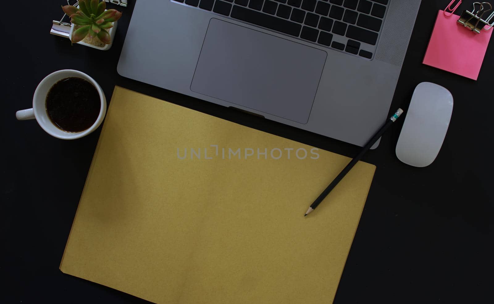 Business desk with laptop and memo paper placed on a black background, including a copy area to add text or graphics. by noppha80