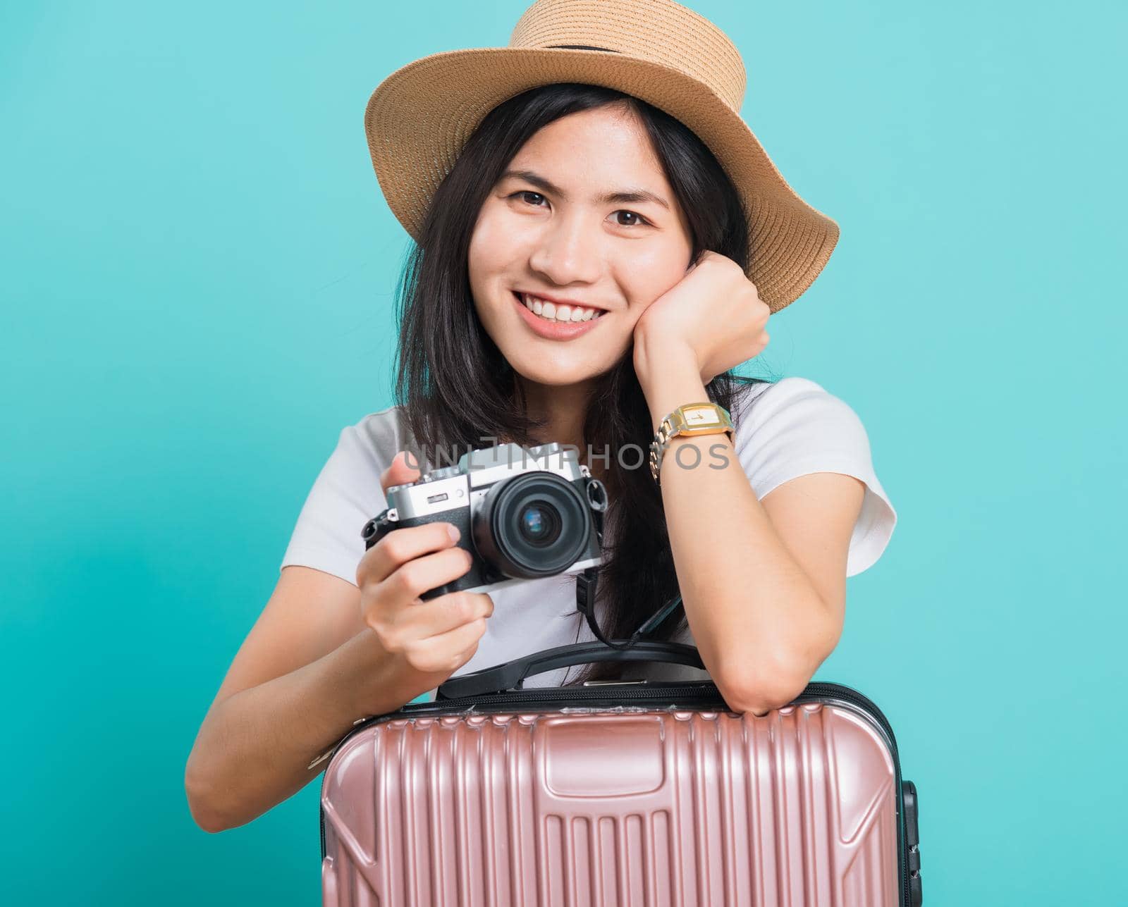 woman wear white t-shirt her holding suitcase bag and photo mirrorless camera by Sorapop