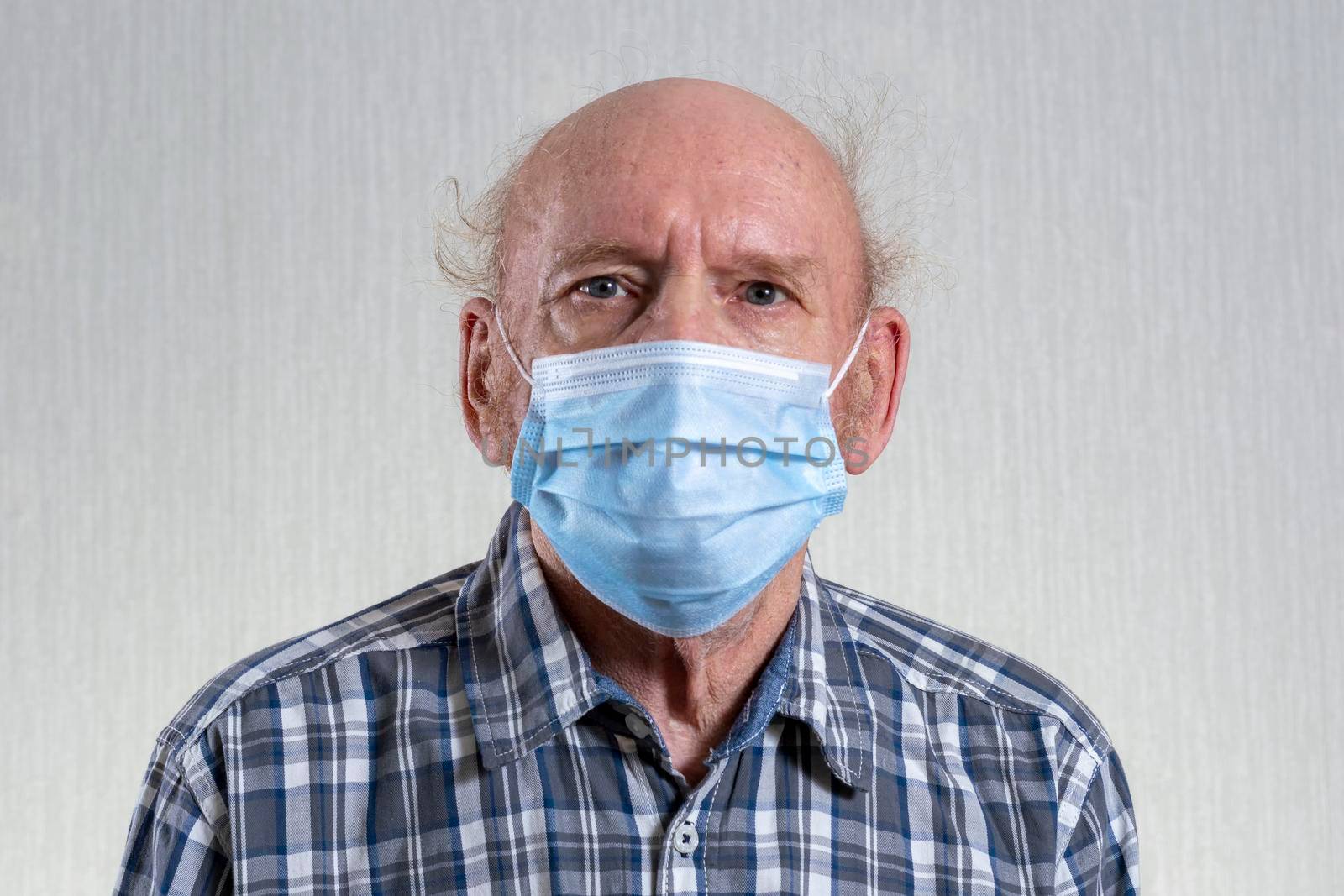 Old bald man in mask. Indoors in daylight. Front view. by Essffes