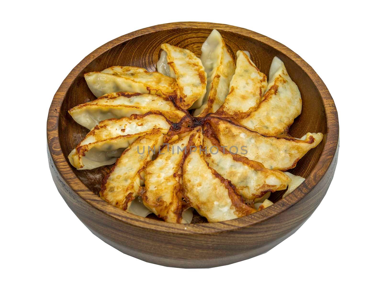 Asian dinner : Fried japanese gyoza dumplings on wooden bowl isolated on white background with clipping path. Selective focus.