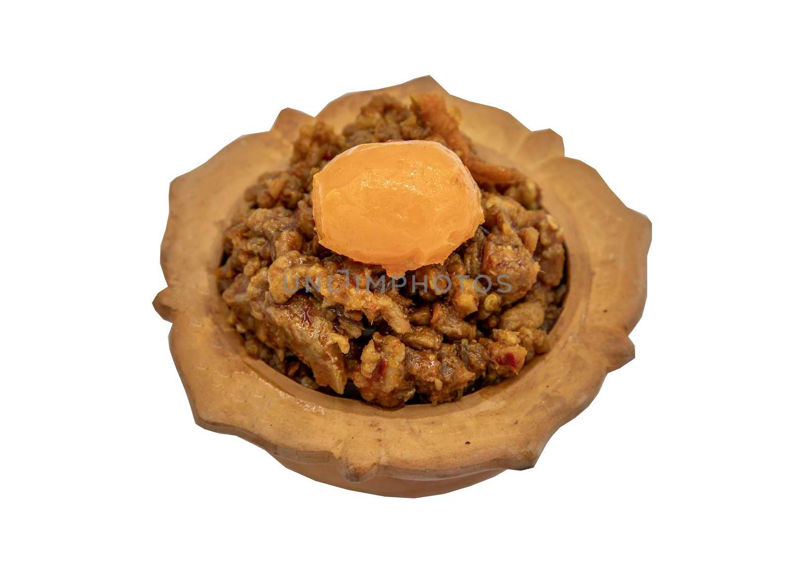 Thai style food : Stir-Fried Pork Crackle with Curry Paste (Fried ginger pork with salted duck egg) isolated on white background with clipping path. Selective focus.