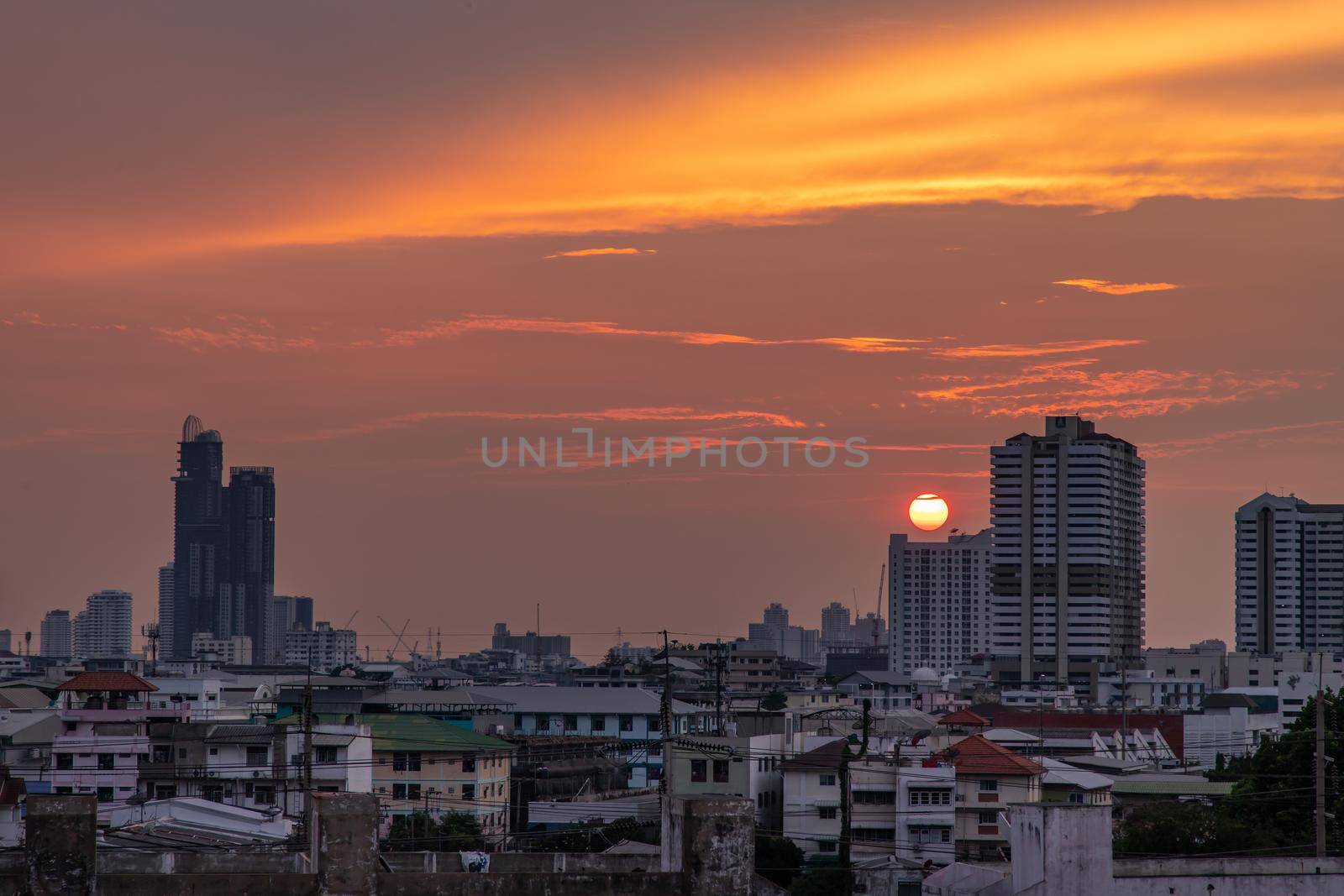 Bangkok, Thailand - 11 Apr, 2020 : Skyscrapers Bangkok City in the light of the setting sun silhouetted cities at sunset. Beautiful sunset over office building center. Selective focus.