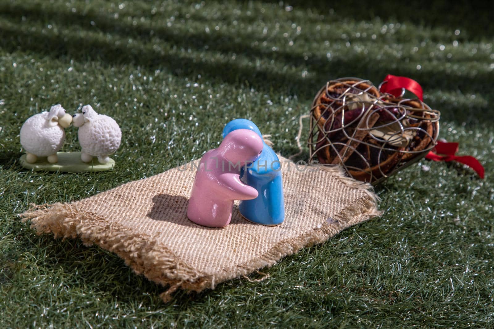 Sheep ceramic couple dolls Kissing and ceramic couple dolls hug on lawn. Love concept. by tosirikul