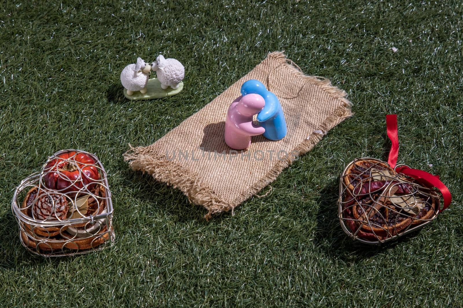 Sheep ceramic couple dolls Kissing and ceramic couple dolls hug on lawn. Love concept. by tosirikul