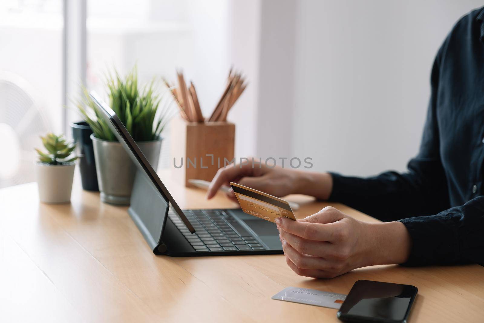 Close up hand of woman making online payment using laptop for shopping at home