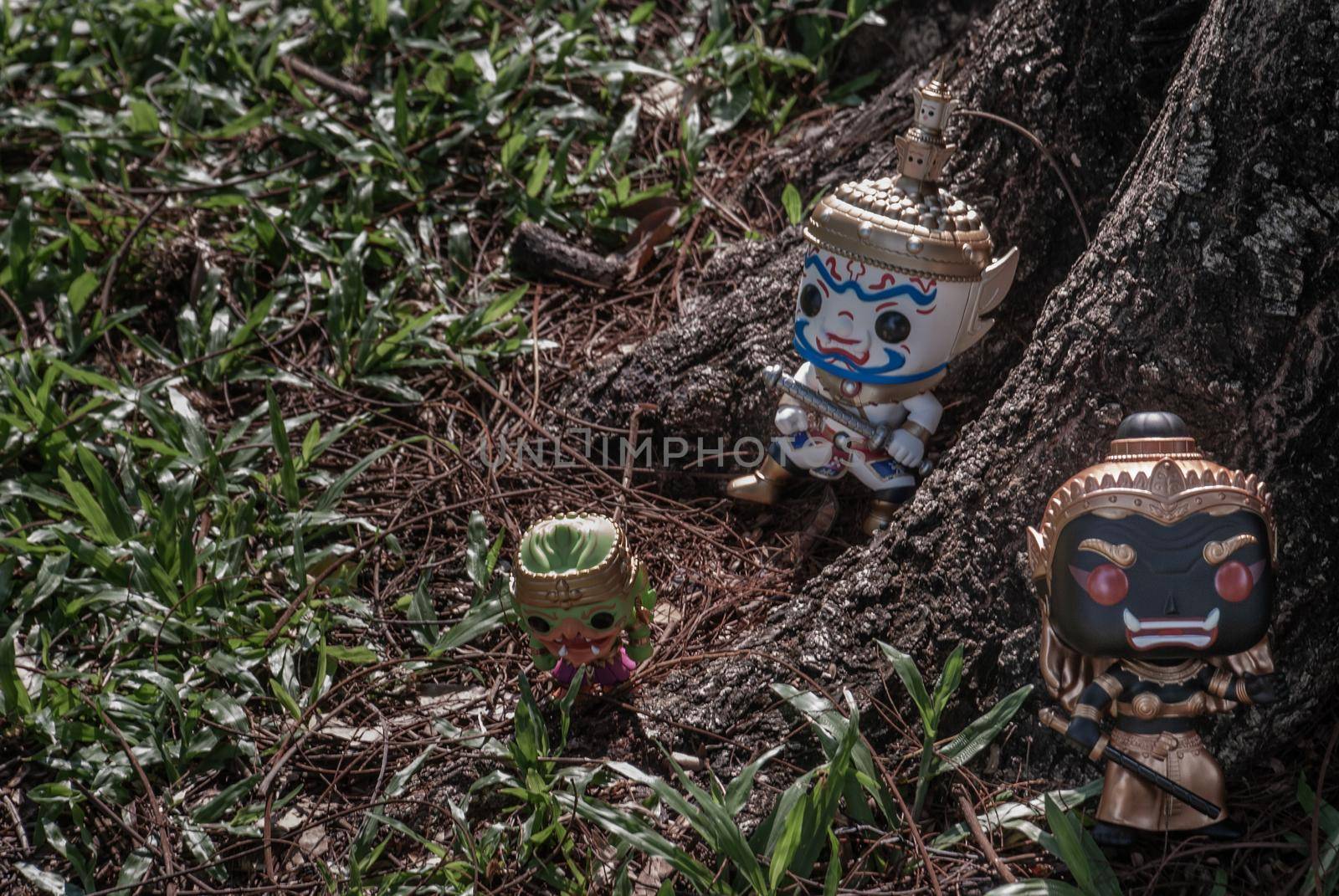 Ravana, Giantess and Hanuman. Standing on the base of a large tree at the park. Traveller doll.