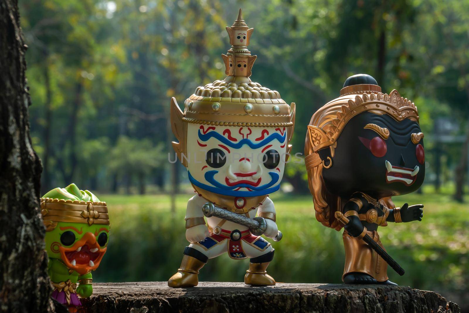 Ravana, Giantess and Hanuman. Standing on the base of a large tree at the park. Traveller doll.