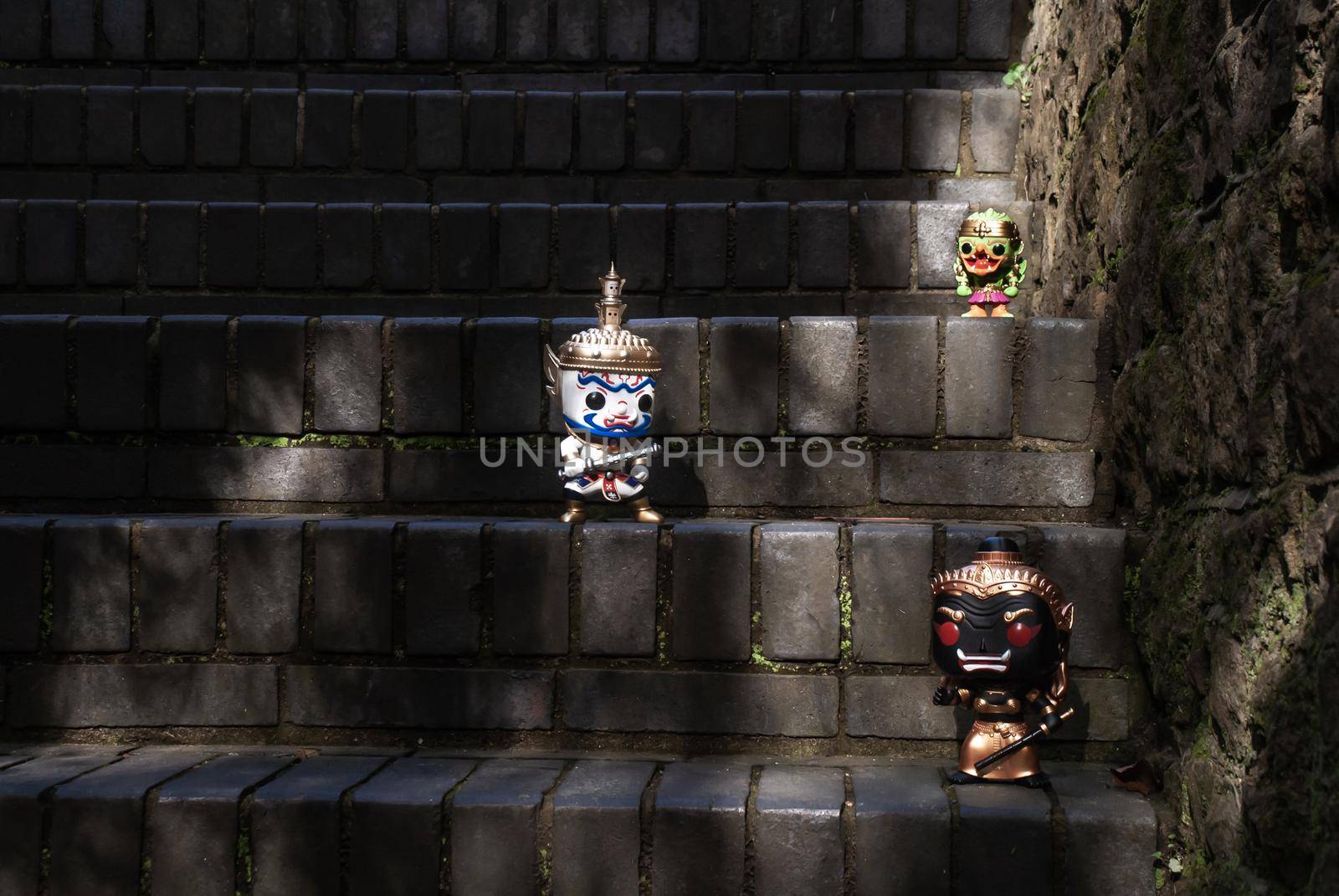 Ravana, Giantess and Hanuman. Standing on a stone stairway with light shining down. Traveller doll.