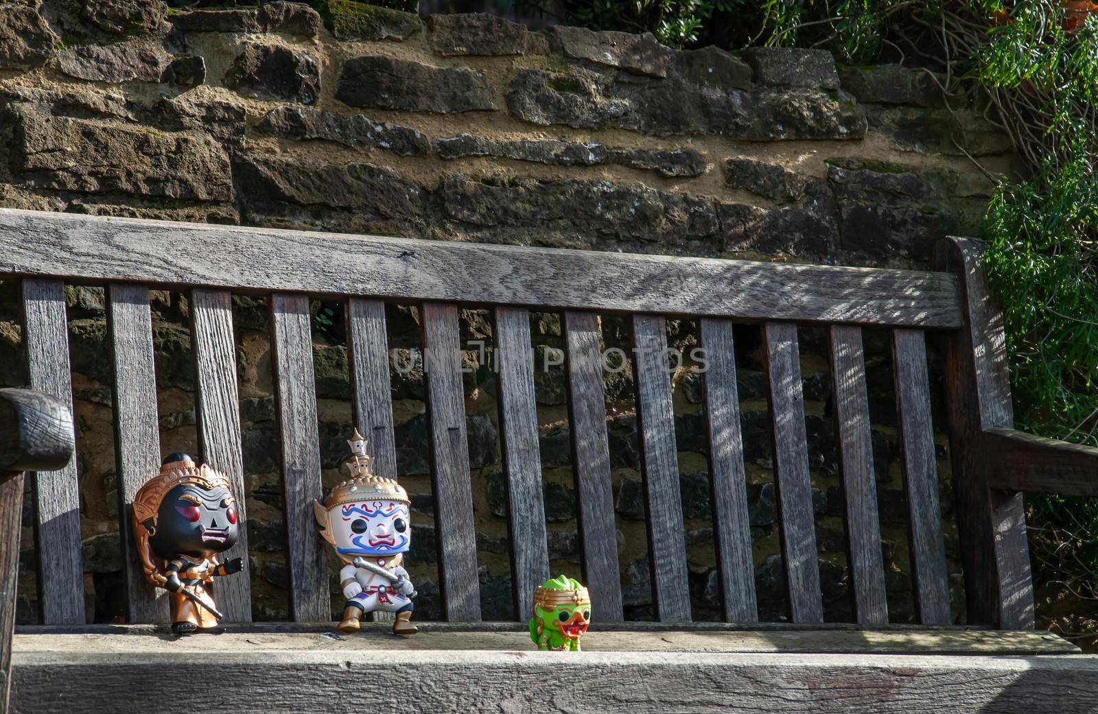 London, England - Jan 24, 2019 : Ravana and Giantess Sitting on the wooden chair at the park. Traveller doll. No focus, specifically.