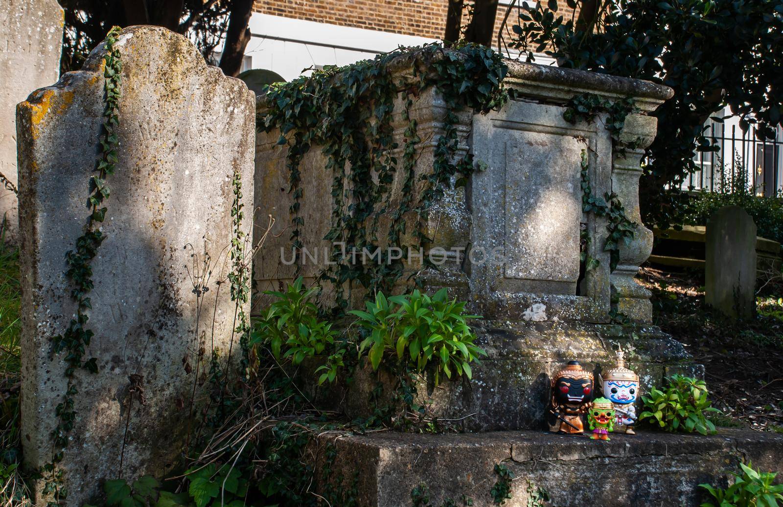 London, England - Jan 24, 2019 : Ravana, Giantess and Hanuman Standing on the grave sign In the cemetery. Traveller doll. No focus, specifically.