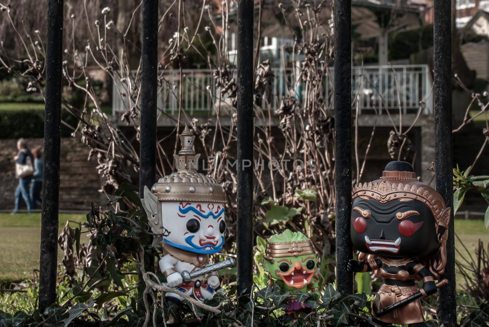 Ravana, Giantess and Hanuman Standing on the wall of the iron fence in the park. Traveller doll.