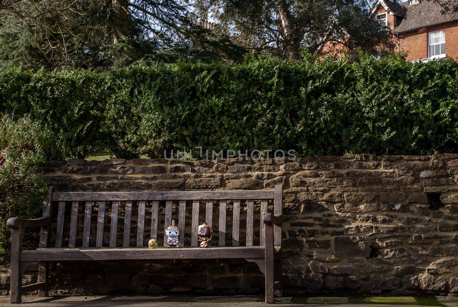 Ravana and Giantess Sitting on the wooden chair at the park. Traveller doll.